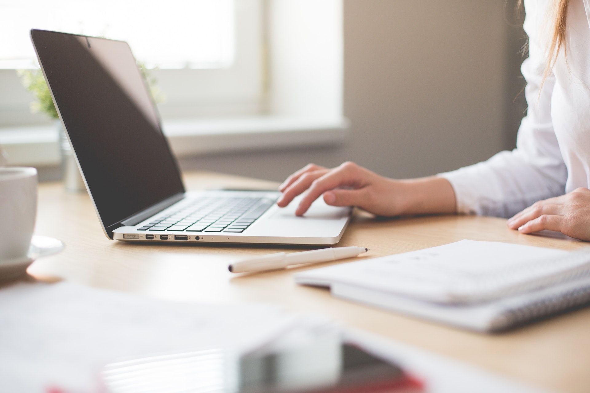 image of woman sitting at desk with computer